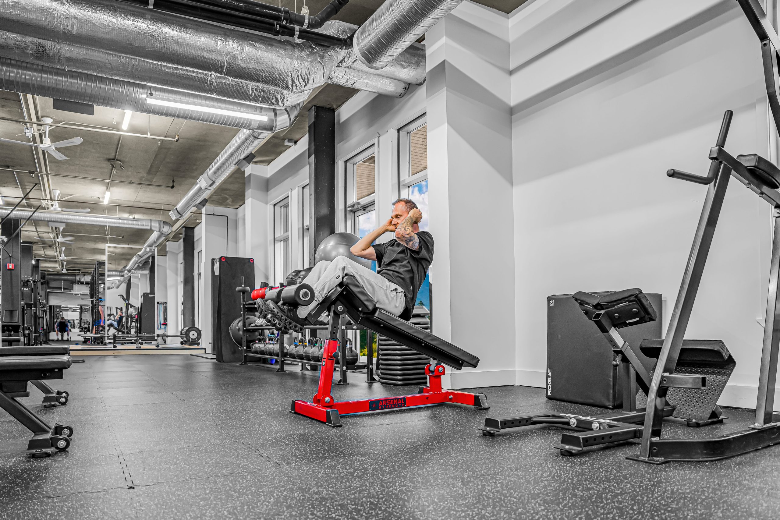 Decline sit-up bench with foot rollers at Athletic Evolution