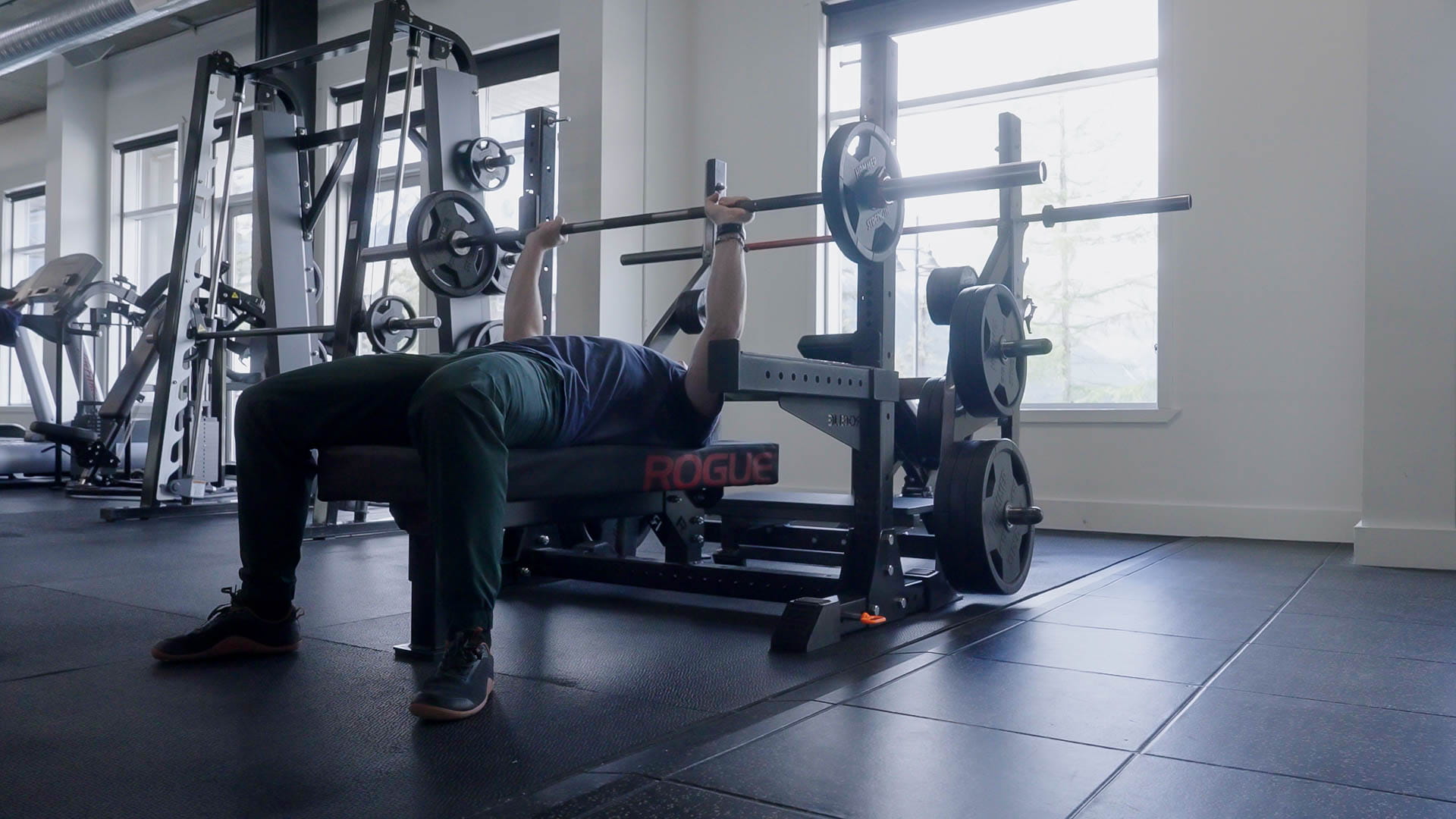 Flat bench press with Rogue rack and safety arms at Athletic Evolution