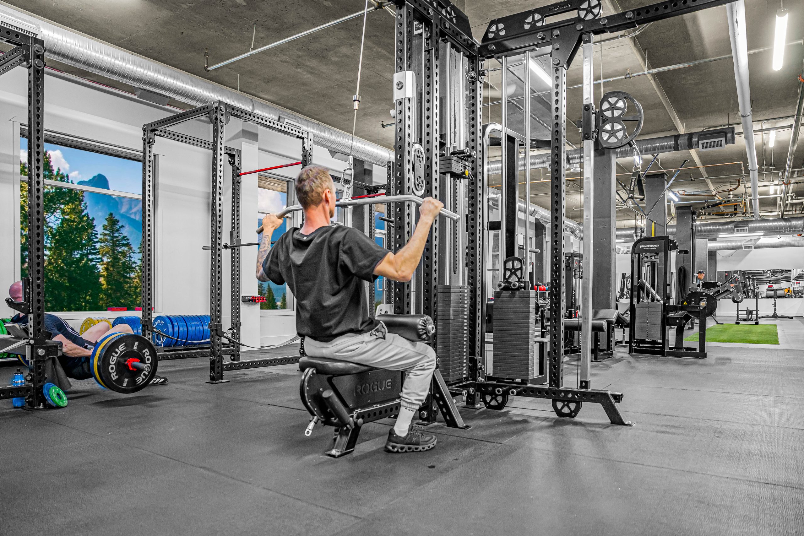 Lat pulldown station with multiple grip handles at Athletic Evolution