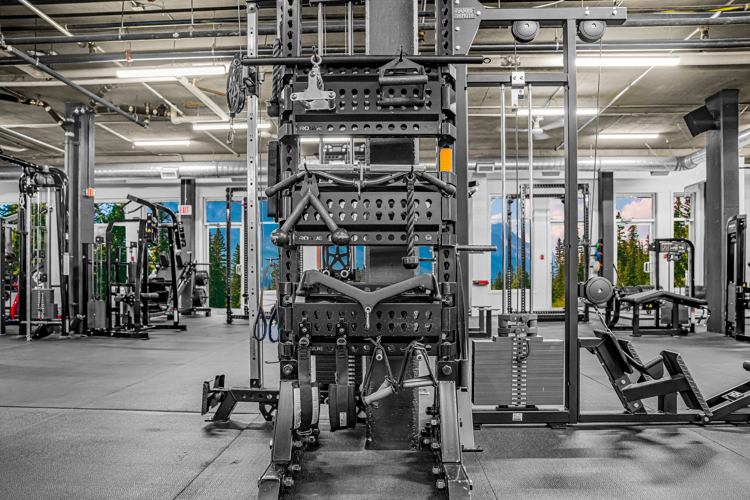 Wall of cable attachments including ropes, bars, and handles at Athletic Evolution